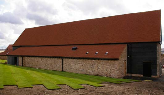 Rear of restored barn next to Channel Tunnel Rail Link